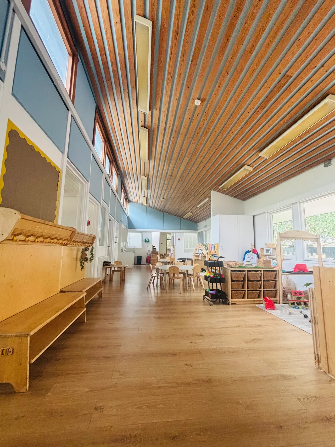 Refurbished open-plan classroom at Blue Nest Montessori, Aldershot, with timber-slatted ceiling and new flooring